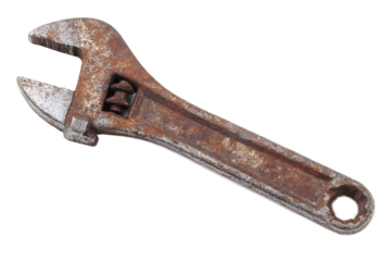 Old wrench on a plain background showing wear and rust from extended use in various tasks around household or workshop settings