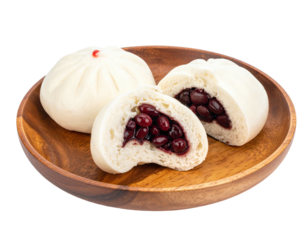 Steamed buns, cut open, filled with dark bean paste on wood