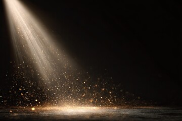 Golden beam shines from above with sparkling dust falling on a dark surface