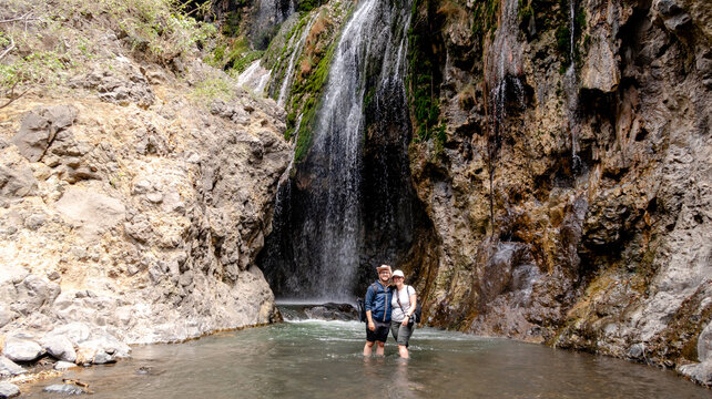 Couple enjoying Engare Sero Waterfall in Tanzania