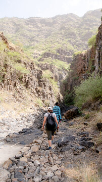 Female tourist hiking toward Engare Sero Waterfall