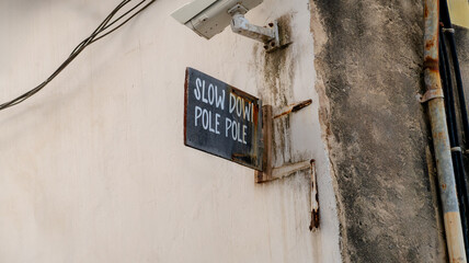 Rustic traffic sign on wall in Zanzibar street view