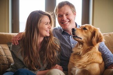 Family sitting with golden retriever at home