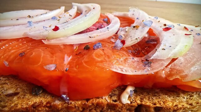 Smoked salmon on toast with sliced onions and seasonings comfort food