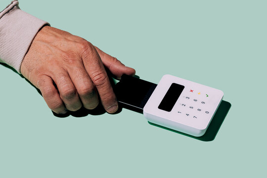 Hand using card reader for contactless payment