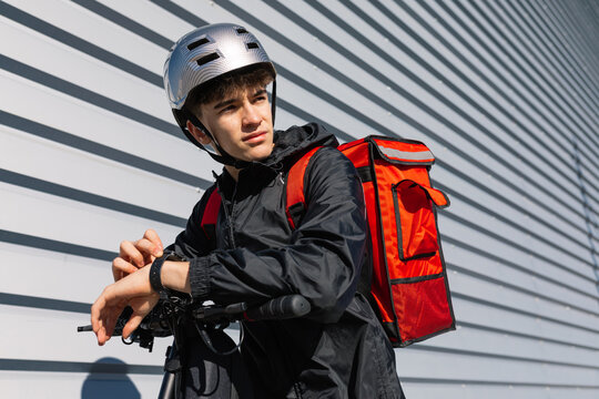 Young delivery boy on an electric scooter