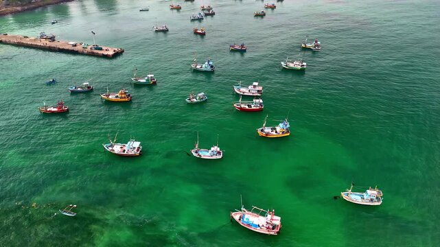 Fishing boats anchored in the turquoise waters near Weligama Fisherman&rsquo;s Village, Sri Lanka, forming a colorful maritime pattern along the calm coast.
