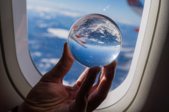 View of the Alps through an airplane window crystal ball