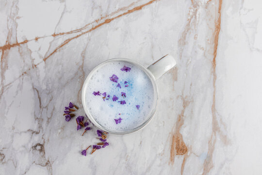 Blue matcha latte with purple flower petals