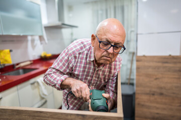Active senior engaged in home kitchen renovation