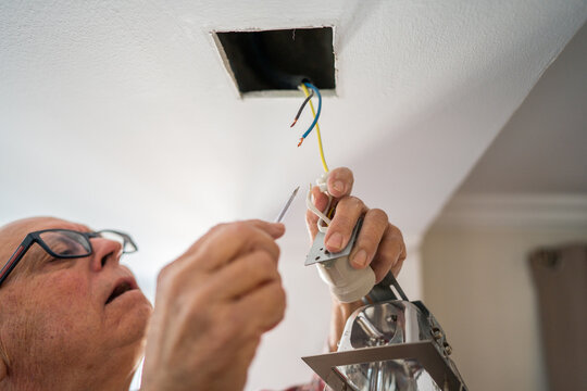 Active senior enjoying DIY project in kitchen renovation