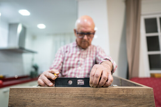 Active senior engaged in kitchen renovation project