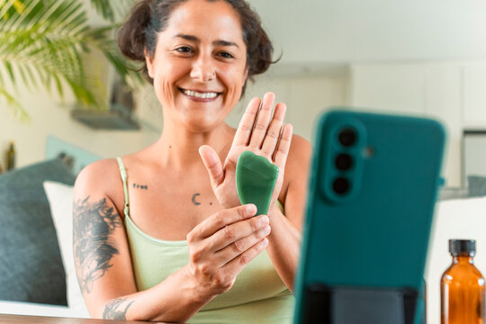 Woman enjoying skincare routine with video tutorial