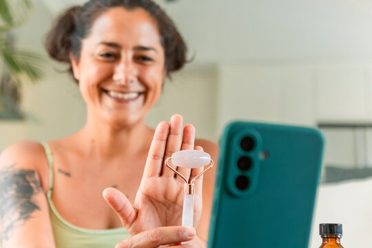 Woman demonstrating skincare in video tutorial at home