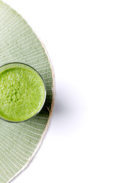 Refreshing green smoothie on woven placemat