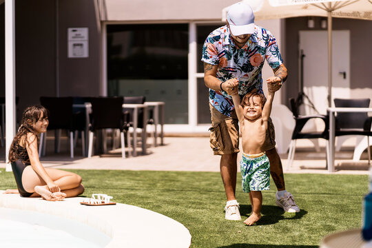Family enjoying summer day by the pool together