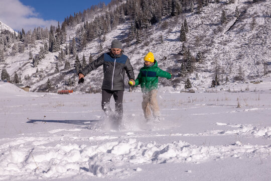 Snowy valley walk with family enjoying winter outdoors
