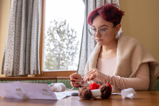 Young woman crafting in cozy home environment