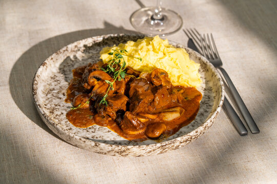 Beef bourguignon with mashed potatoes and herbs