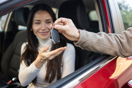 Happy woman receives car keys for road trip journey