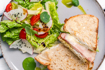 Fresh lettuce salad with ham and cheese toast