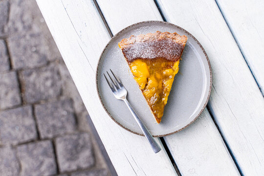 Delicious slice of mango cake on a white table