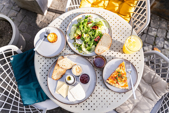 Outdoor brunch with quiche and healthy salad options