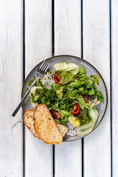 Fresh salad with sourdough bread and healthy vegetables