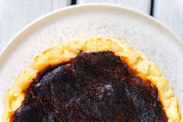 Basque cheesecake on rustic plate with burnt top