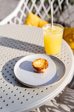 Portuguese nativity cake and orange juice on white table outdoors