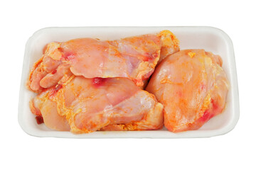 Marinated chicken thighs in plate isolated in white background. Cooking food at home. Raw meat for cooking.