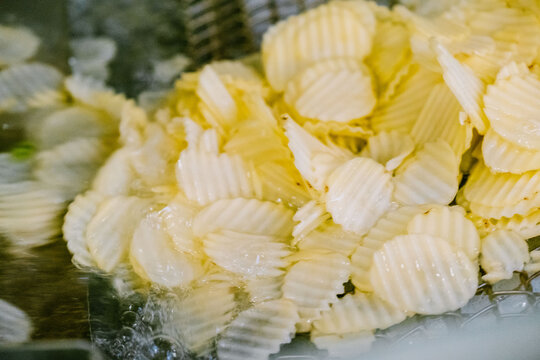 Freshly washed potato slices in factory production