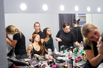 Photoshoot preparation with diverse models and makeup artists