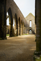 The abbey nave ruins at St Matthew point, a headland located in the commune of Plougonvelin in Finistere, Brittany, France. Side view with clouds, no people.