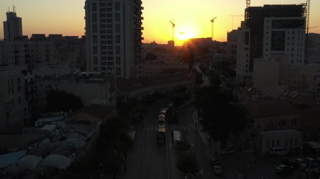 Aerial Jerusalem Sunset Light Rail

Drone footage of Jerusalem city center at sunset with the light rail traveling along Jaffa Road, urban skyline glowing in evening light, December 24 2025.
