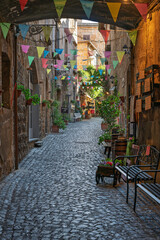 Italy - Orvieto - Orvieto Old Town - Charming medieval alley decorated with colorful festive flags