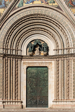 Italy - Orvieto - Duomo di Orvieto - Detail of the central portal with intricate bronze door and carved archivolts