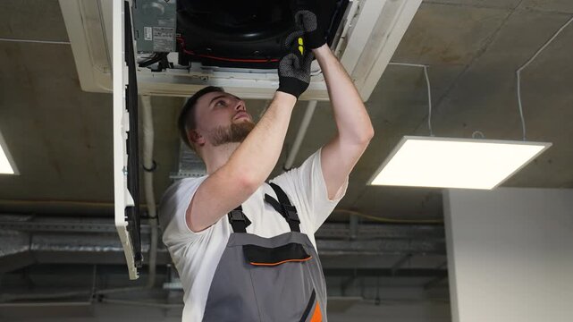 Professional technician installing a ceiling ventilation system