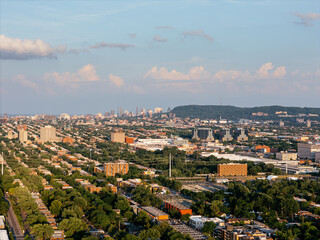 Obraz premium Aerial view of Ahuntsic Park with pond, trees and surrounding urban neighborhood in summer. g.