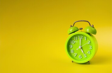Green alarm clock on yellow background