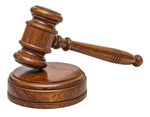 Close-up studio shot of a brown wooden gavel, resting on a round base