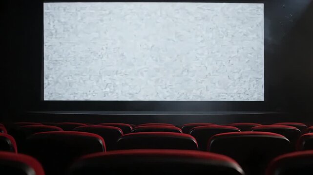 Back Row View of Empty Movie Theater with Aggressive Static Noise on Screen and Visible Projector Beam through Haze