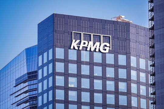Building exterior and logo or brand or sign of KPMG Italy.