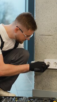Professional electrician installing a wall socket