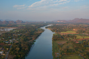 Fototapeta premium Aerial view from a drone of misty morning over the Kwai river in Kanchanaburi, Thailand