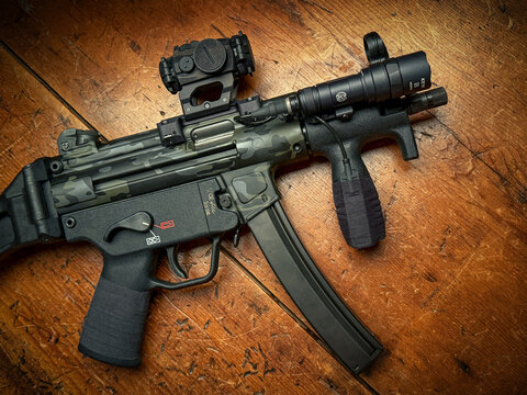 	
Heckler & Koch SP5K PDW. Limited edition Cerakote paint, Aimpoint T-2 Micro Red dot, Surefire Mini Scout pro light and Goon tape fabric wrap grip.	
