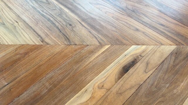 Close up of a hand lifting an empty green bowl from a wooden table. Minimal kitchenware and everyday lifestyle concept.