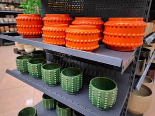 Many-coloured ceramic flower pots in a shop