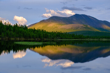 Sunset panorama of small lake with mountain reflection in Siberia, Buryatia, Russia