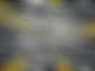 A blurry image of a grey and yellow surface with a few specks of gold